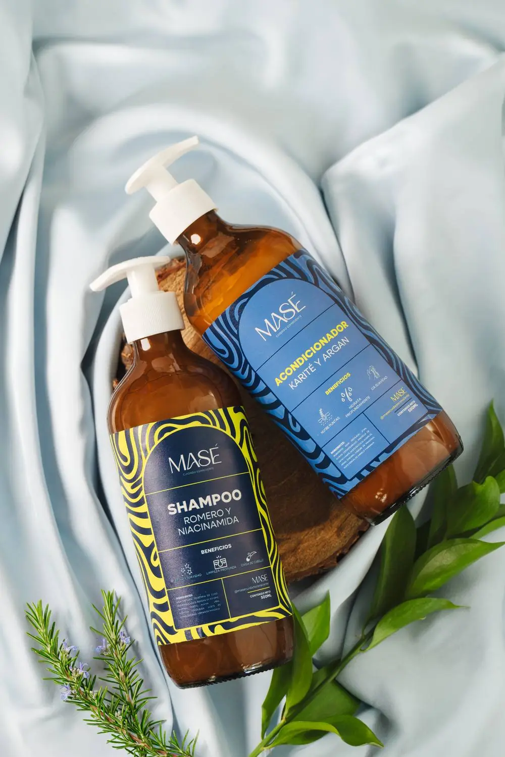 Shampoo y acondicionador MASÉ sobre tela de seda con romero fresco